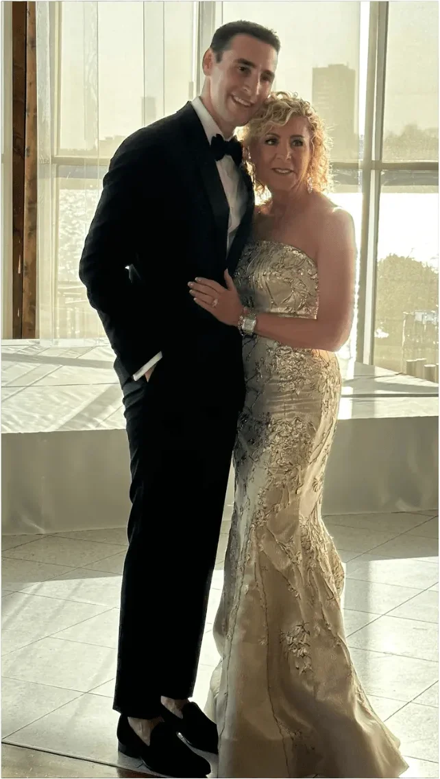 A client at an evening wedding in a champagne beaded gown