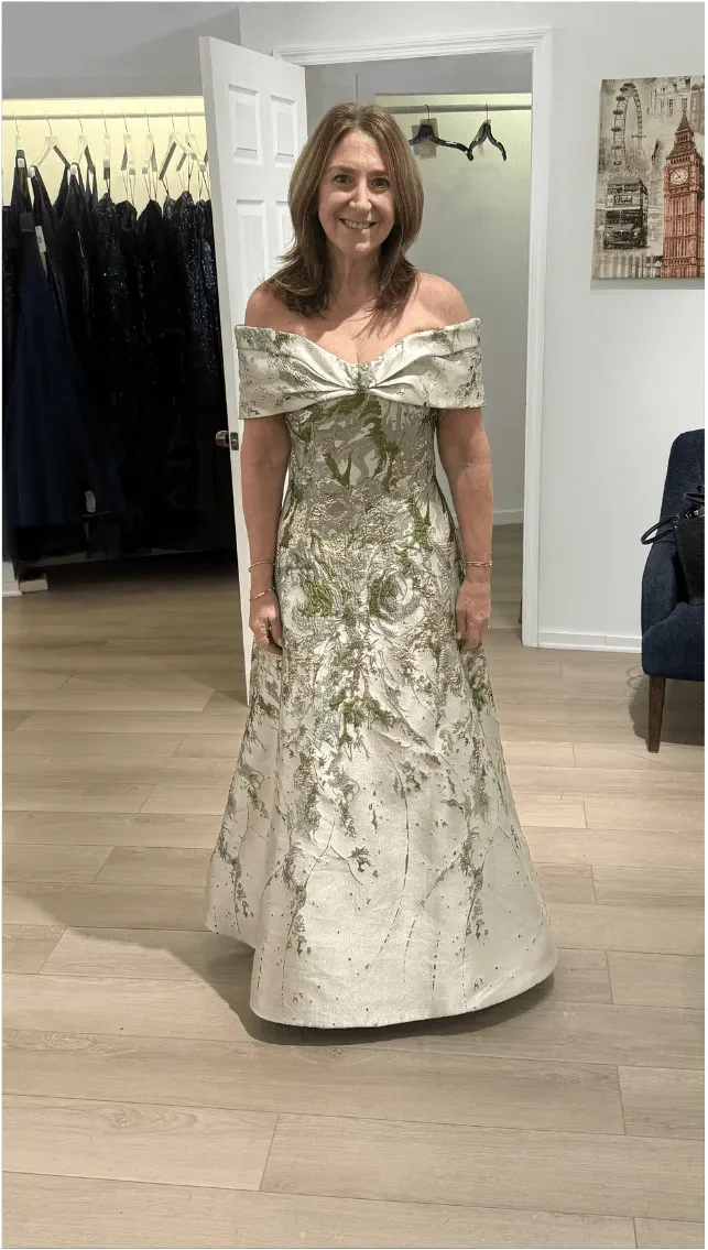 A client in an ivory and gold brocade gown before her event
